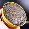 hand holding a tin of kaluga caviar